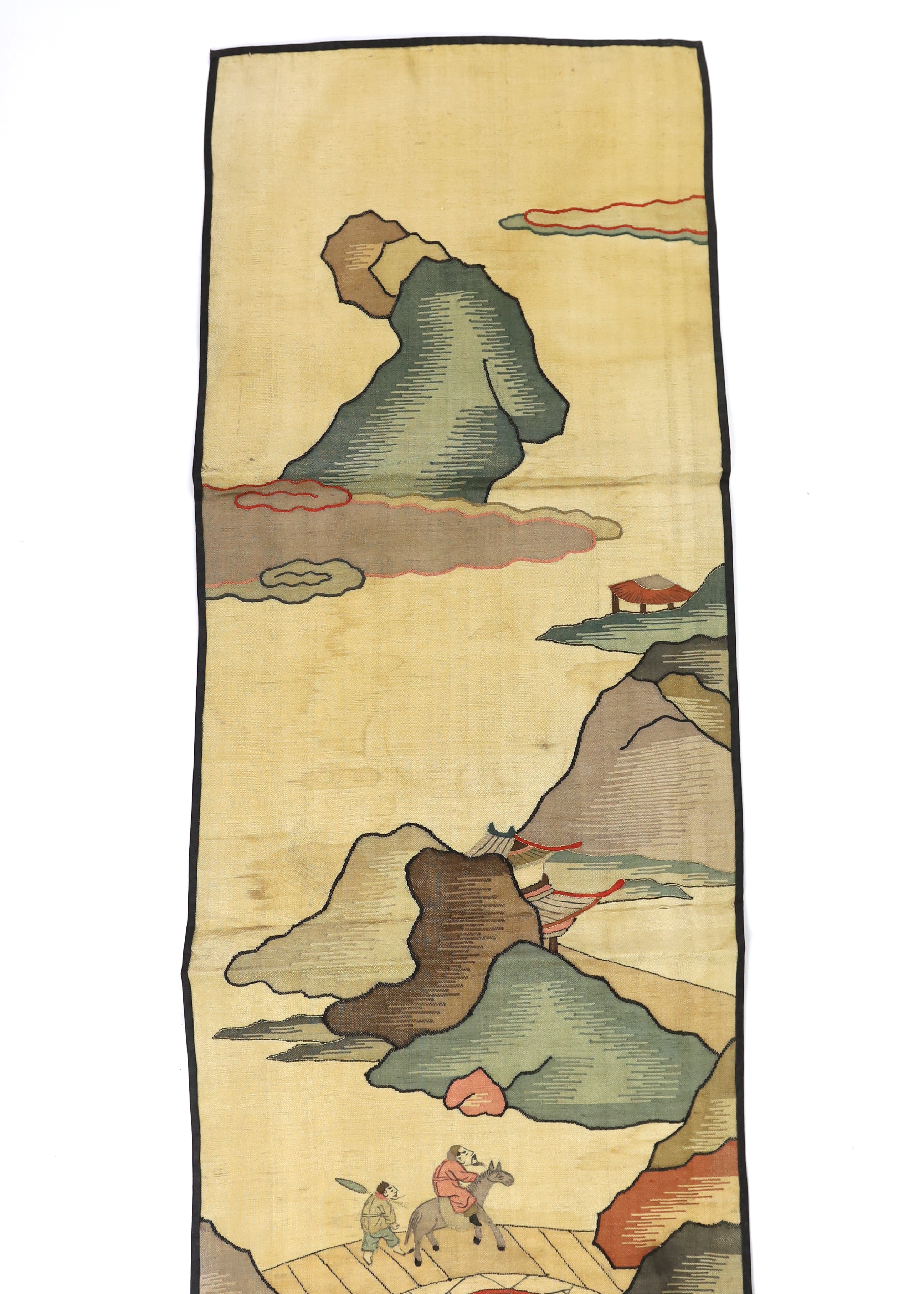 A Chinese late Qing dynasty Kesi polychrome silk hanging, depicting a figure on horseback and another walking within a mountainous landscape, together with a smaller later metallic Kesi panel of stylistic 'lishui waves',